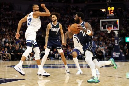 Kyrie Irving drives to the basket in Dallas's road win over the Minnesota Timberwolves