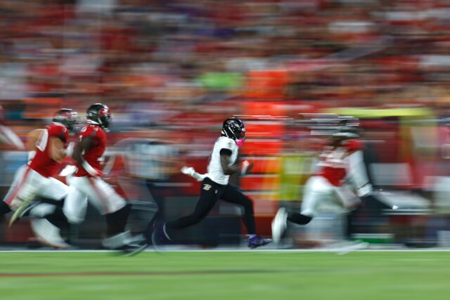 Lamar Jackson sprints clear of Tampa Bay's defense in Baltimore's 41-31 win over the Bucca