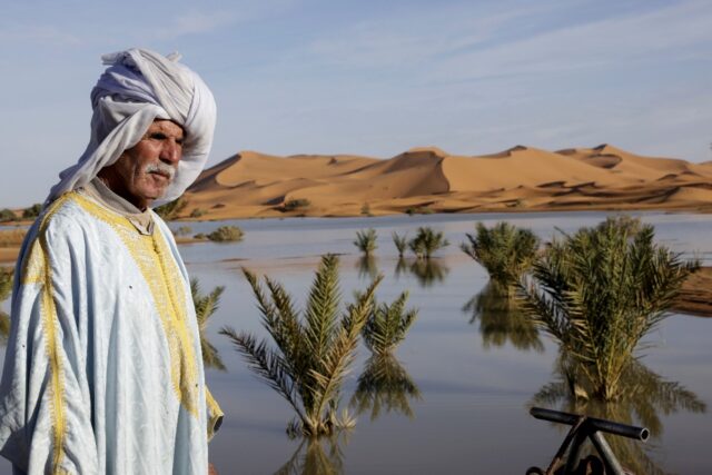 A local man poses for a picture at Yasmina Lake, a seasonal lake in the village of Merzoug