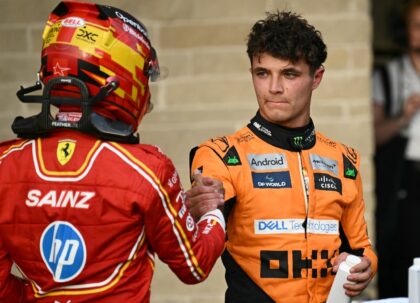 McLaren driver Lando Norris shakes hands with Ferrari's Carlos Sainz after winning the po