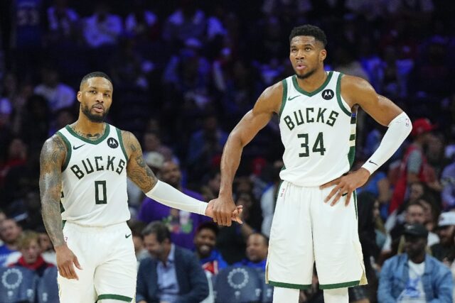 Milwaukee's Damian Lillard and Giannis Antetokounmpo celebrate during the Bucks' NBA victo