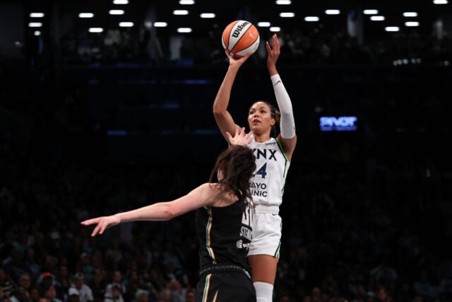 Napheesa Collier of the Minnesota Lynx fires a shot over Breanna Stewart in Minnesota's vi