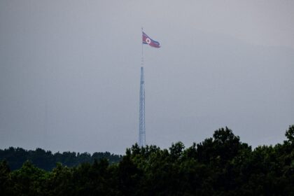 A North Korean flag seen from Paju in South Korea flutters over the village of Gijungdong