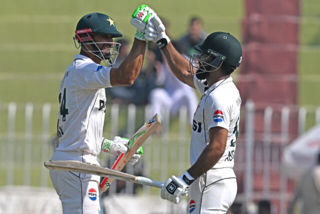 Pakistan's captain Shan Masood and Abdullah Shafique celebrate after winning the third and