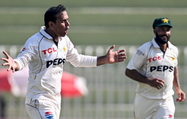 Pakistan's Noman Ali (L) celebrates after taking the wicket of England's captain Ben Stoke