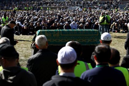 People pray over the casket of Turkish Muslim cleric Fethullah Gulen during a service at S