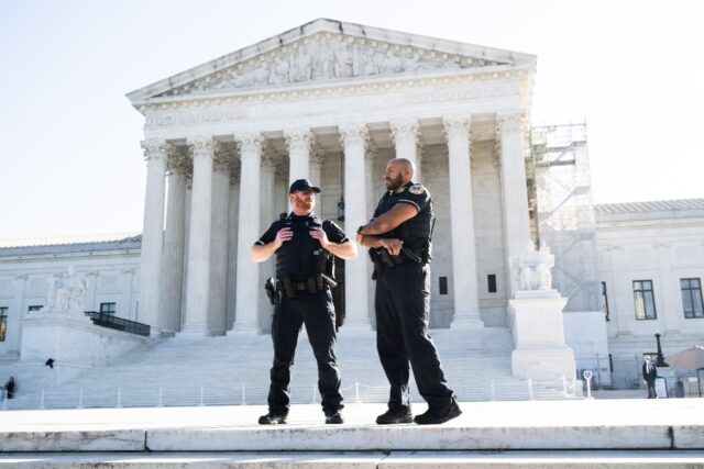 Police officers outside the US Supreme Court as it begins its 2024 fall term