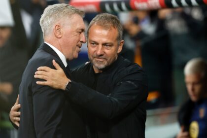 Real Madrid's Italian coach Carlo Ancelotti (L) and Barcelona's German coach Hansi Flick h