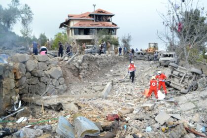 Red Cross paramedics unearth a body at the site of an Israeli air strike that targeted the