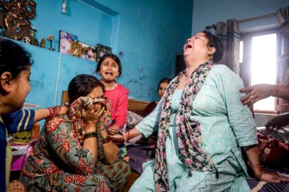 Relatives of one of those killed in an attack in Kashmir mourn the death