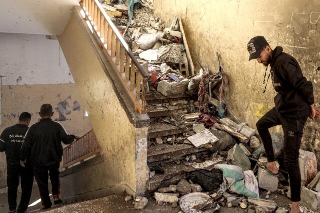 A stairwell littered with rubble and debris in central Gaza's Al-Shuhada school, which was