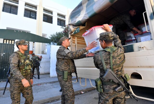 Tunisian soldiers deliver ballot boxes to a polling station in Ariana near Tunis a day bef