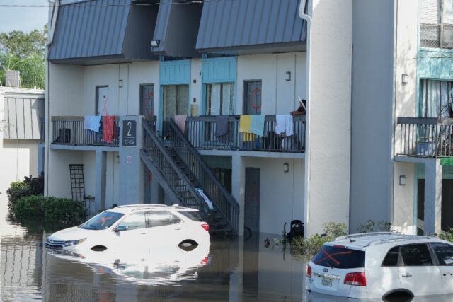 Vehicles are flooded in an apartment complex in Clearwater, Florida, following the passage