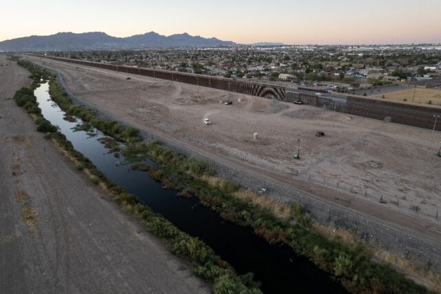 Vehicles guard the US side of the border with Mexico