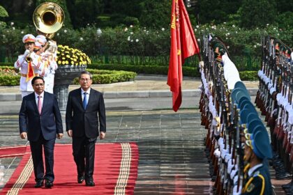 Vietnam Prime Minister Pham Minh Chinh (left) and China's Premier Li Qiang inspect a guard