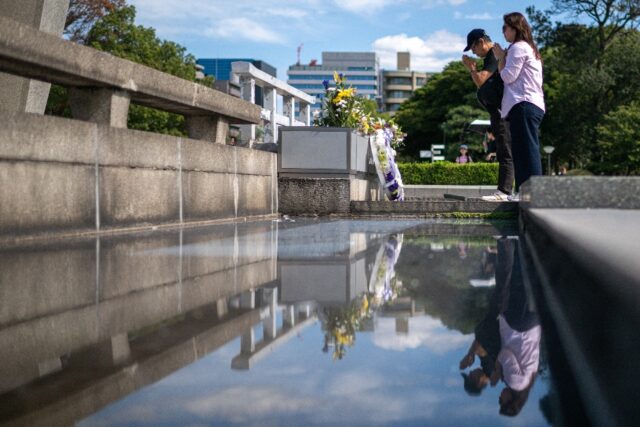 Visitors pray at the Hiroshima Peace Memorial Park in Hiroshima city on Saturday