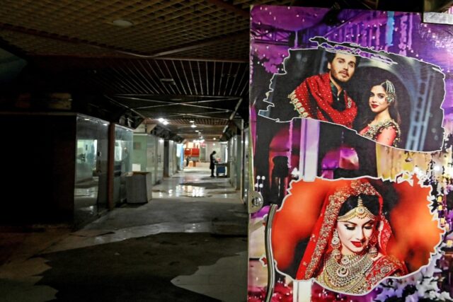 Wedding pictures are displayed outside a marriage bureau office in Pakistan, where apps ar