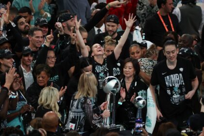 WNBA commissioner Cathy Engelbert, at center front presenting the championship trophy to t