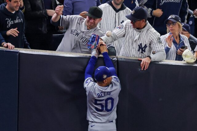 Two New York Yankees fans who interfered with Los Angeles Dodgers outfielder Mookie Betts