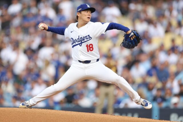 Yoshinobu Yamamoto of the Los Angeles Dodgers delivers a pitch in a series-clinching victo