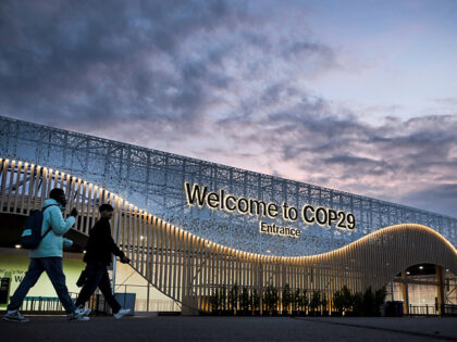 Pedestrian walk in front of the venue for COP 29 Summit in Baku on November 10, 2024, on t