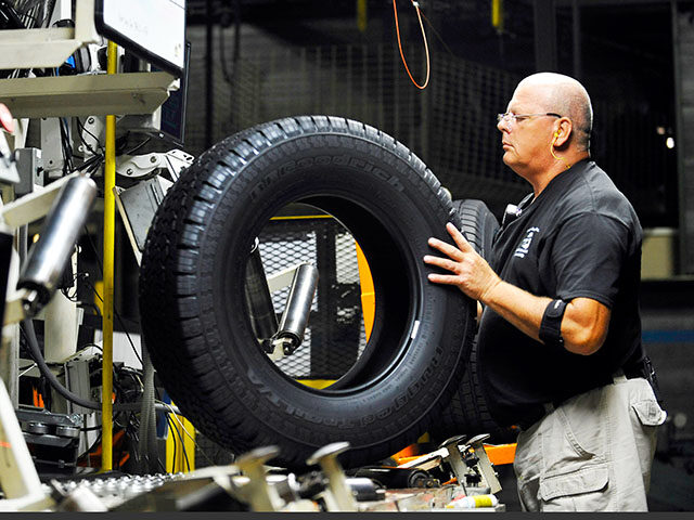 In this Tuesday, July 24, 2012, photo, tire inspector Buddy Rice checks for defects in the