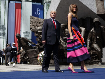 President Donald Trump walks with first lady Melania Trump to deliver a speech at Krasinsk