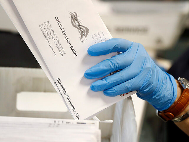 A worker processes mail-in ballots at the Bucks County Board of Elections office prior to