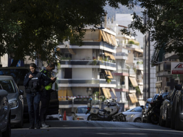 Police officers guard near the entrance of a building following an explosion, which police