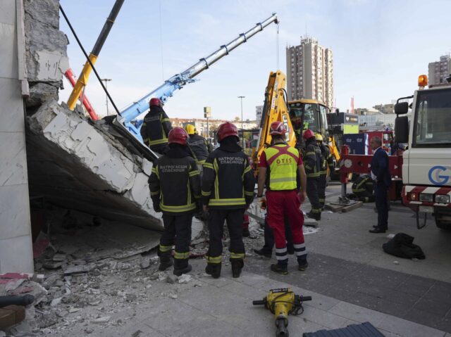 Rescue service workers inspect a scene as a roof collapsed at a railway station, Friday No