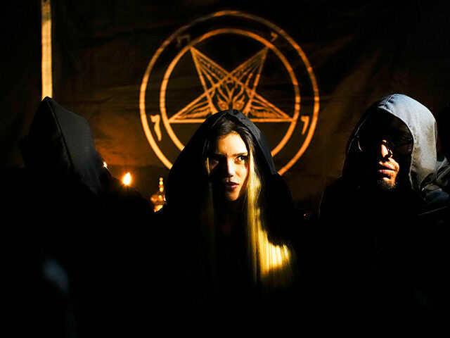 Siuling, center, a member of The Temple of Satan: Satanists and Luciferians of Chile, take