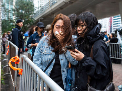 People leave the West Kowloon Magistrates' Courts in Hong Kong Tuesday, Nov. 19, 2024, fol