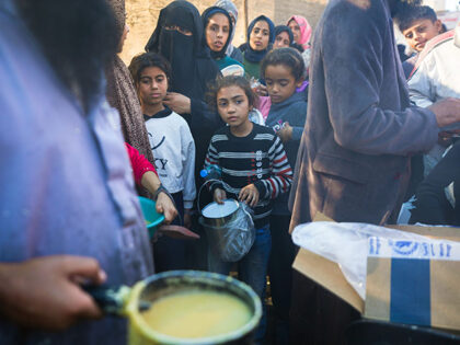 Palestinians queue for food in Deir al-Balah, Gaza Strip, Monday, Nov. 18, 2024. (AP Photo