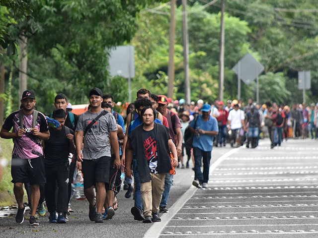 Migrants walk through Tapachula, Chiapas state, Mexico, Wednesday, Nov. 20, 2024, hoping t