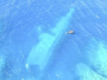 FILE - In this photo provided by the New Zealand Defence Force, divers survey the area aro