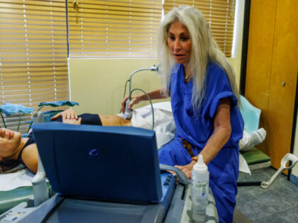 Dr. Barbara Zipkin with nurse Darby Hidden, right, performs an ultrasound on a 25 year old