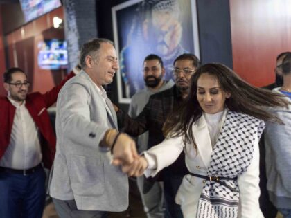 Wasel Yousaf, left, dances with Mona Salama, as they celebrate during an Arab Americans fo