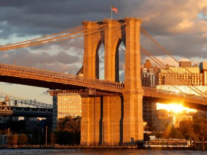 NEW YORK, NY - OCTOBER 15: The sun sets on the Brooklyn Bridge on October 15, 2024, in New