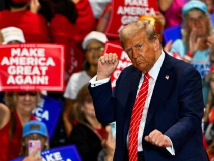 Former US President and Republican presidential candidate Donald Trump dances as he leaves