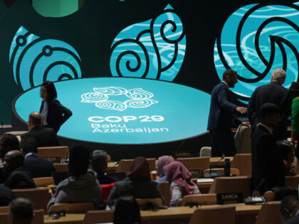 Delegates arrive for a plenary session on the opening day of the UNFCCC COP29 Climate Conf