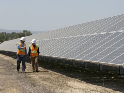 In this Thursday, Aug. 17, 2017 photo, Solar Tech Joshua Valdez, left, and Senior Plant Ma