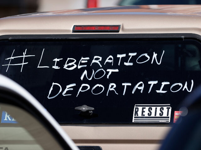 A message is written on the back window of the cab of a pickup truck being used driven dur