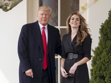 President Donald Trump poses for members of the media with then-White House Communications