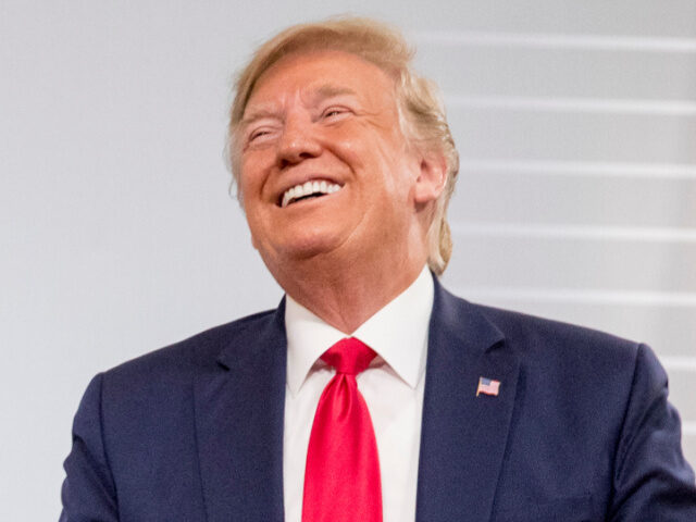 U.S. President Donald Trump and German Chancellor Angela Merkel laugh during a bilateral m