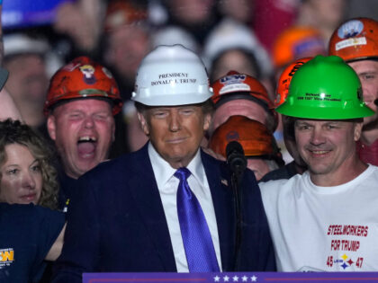 Republican presidential nominee former President Donald Trump stands on stage with steelwo