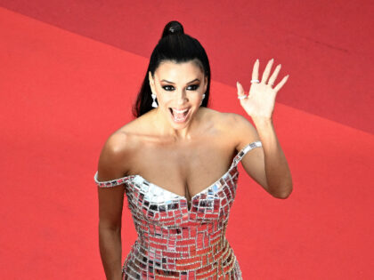 US actress Eva Longoria waves as she arrives for the screening of the film "Top Gun :