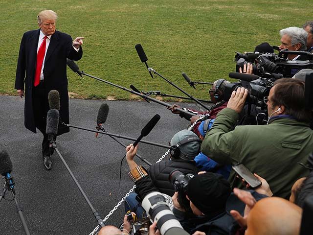 U.S. President Donald Trump talks to reporters before departing the White House March 22,