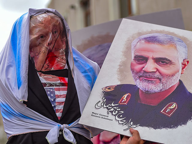 Protesters hold an effigy of US President Donald Trump and a picture of Iranian commander