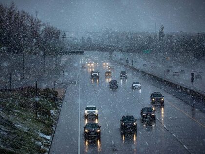 In very heavy snow fall traffic moves on West bound Freeway 210 on Saturday, Feb. 25, 2023