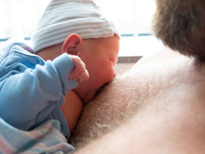 1 day old baby trying to latch on father's nipple